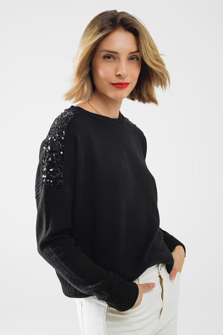 Pull noir à manches longues avec paillettes sur les épaules