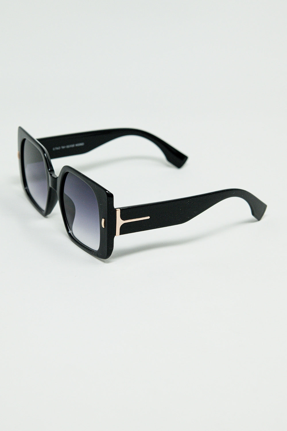 Black square sunglasses with gold detail on the side