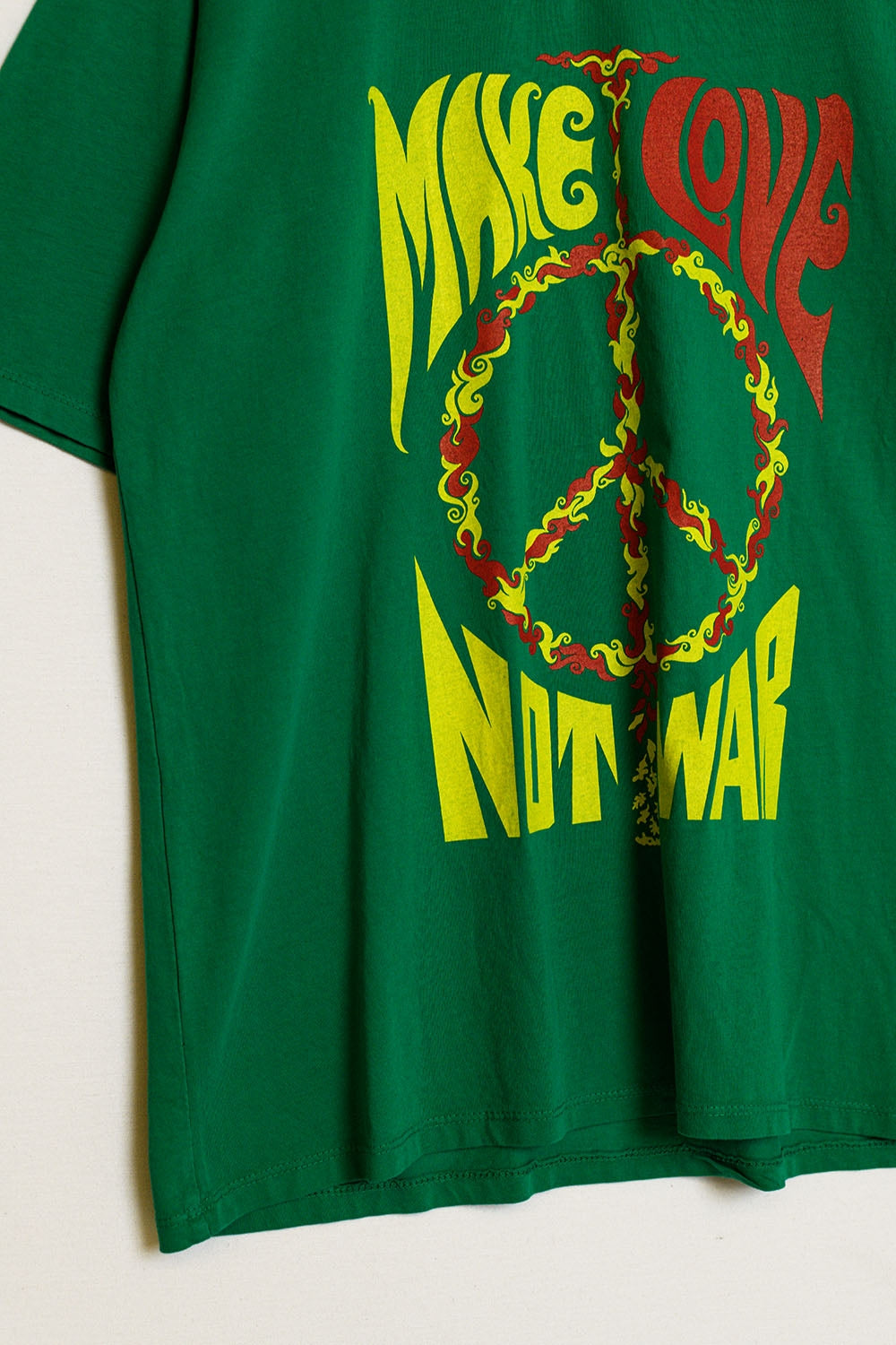 green short sleeve t-shirt with Make love not war logo Q2 Tops BoutiqueLua