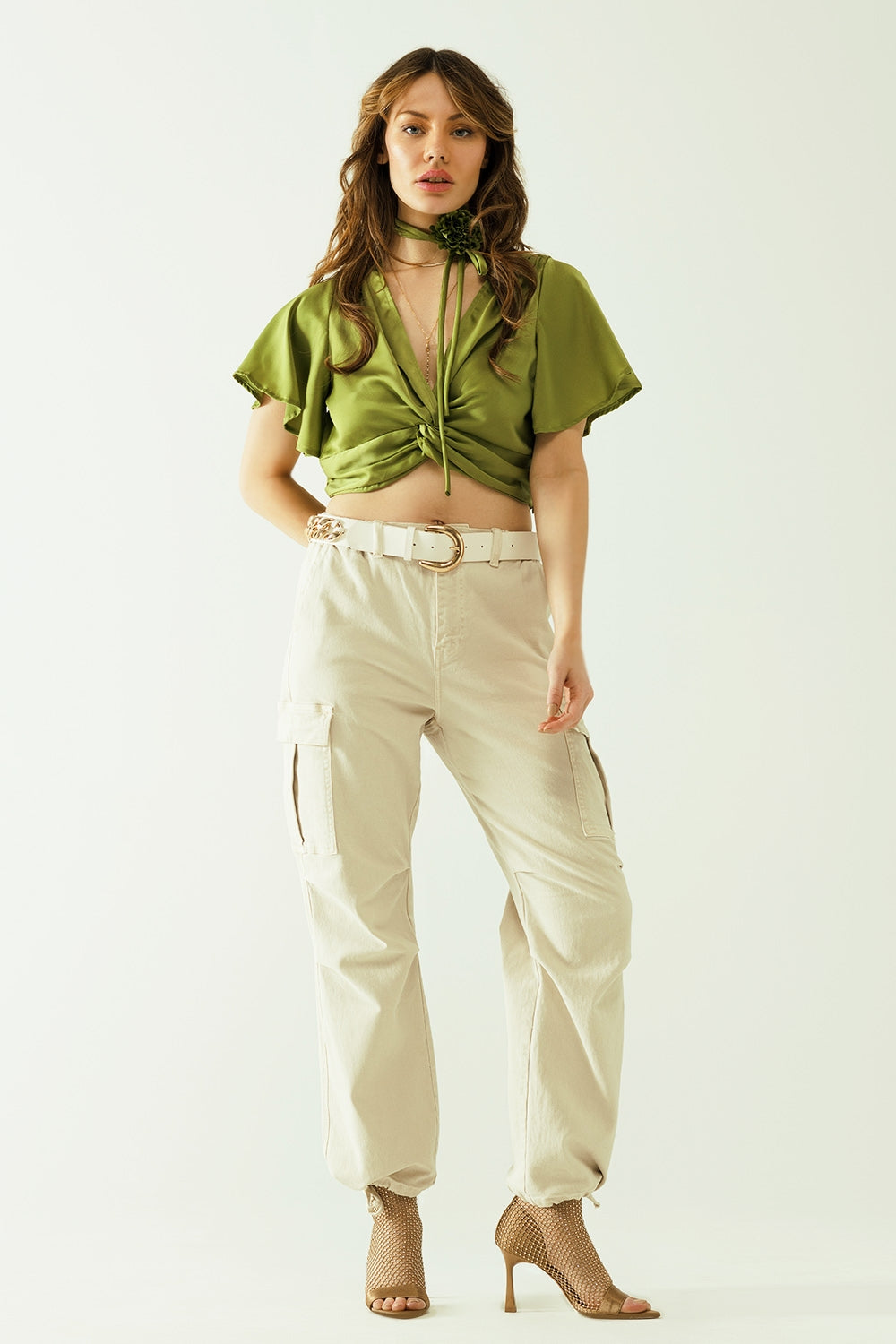 Green V-neck crop top with short sleeves and a flower detail on the neck Q2 Tops BoutiqueLua