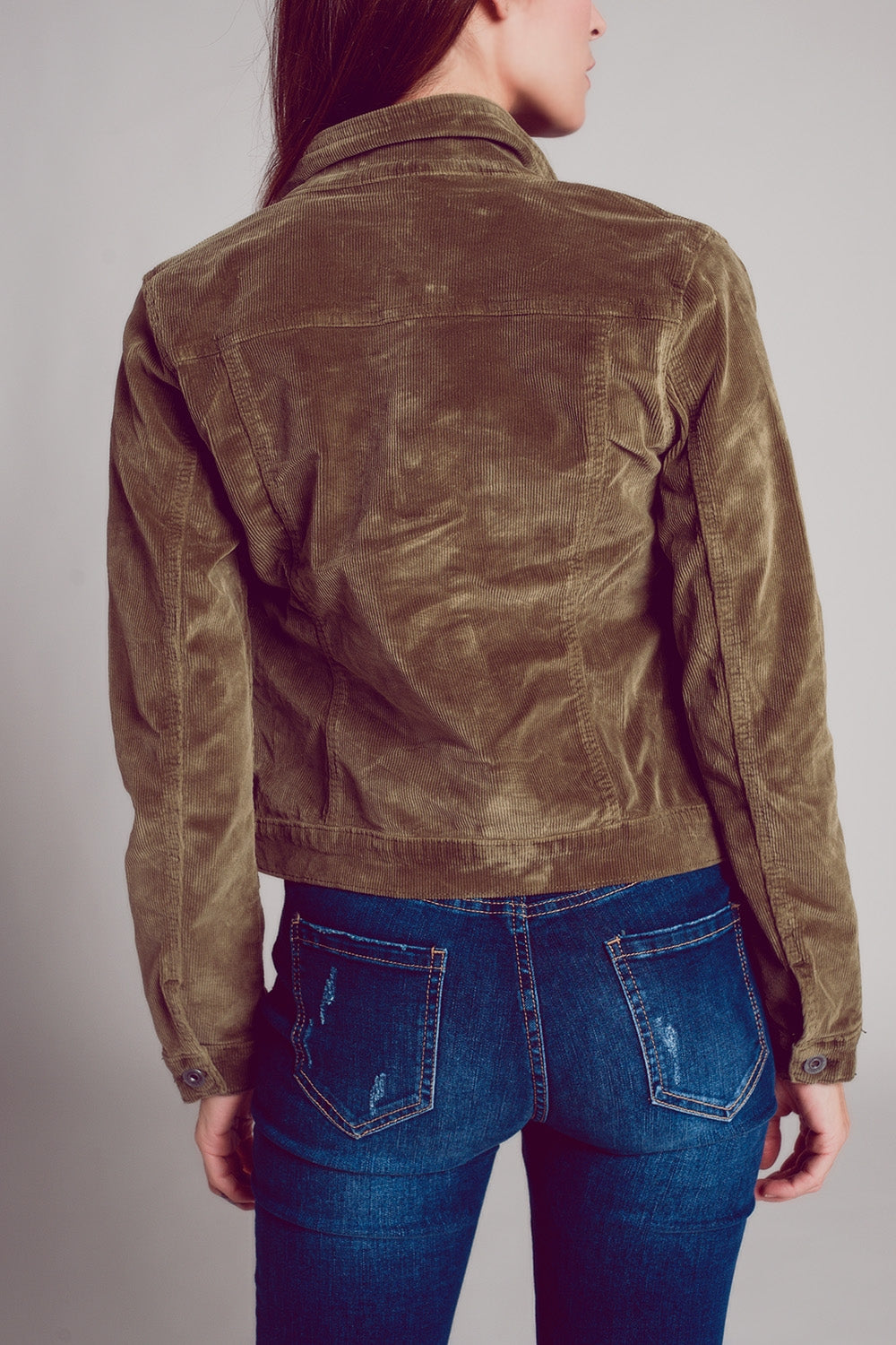 Khaki cropped cord jacket, showing the back view of the jacket on a person wearing blue jeans.