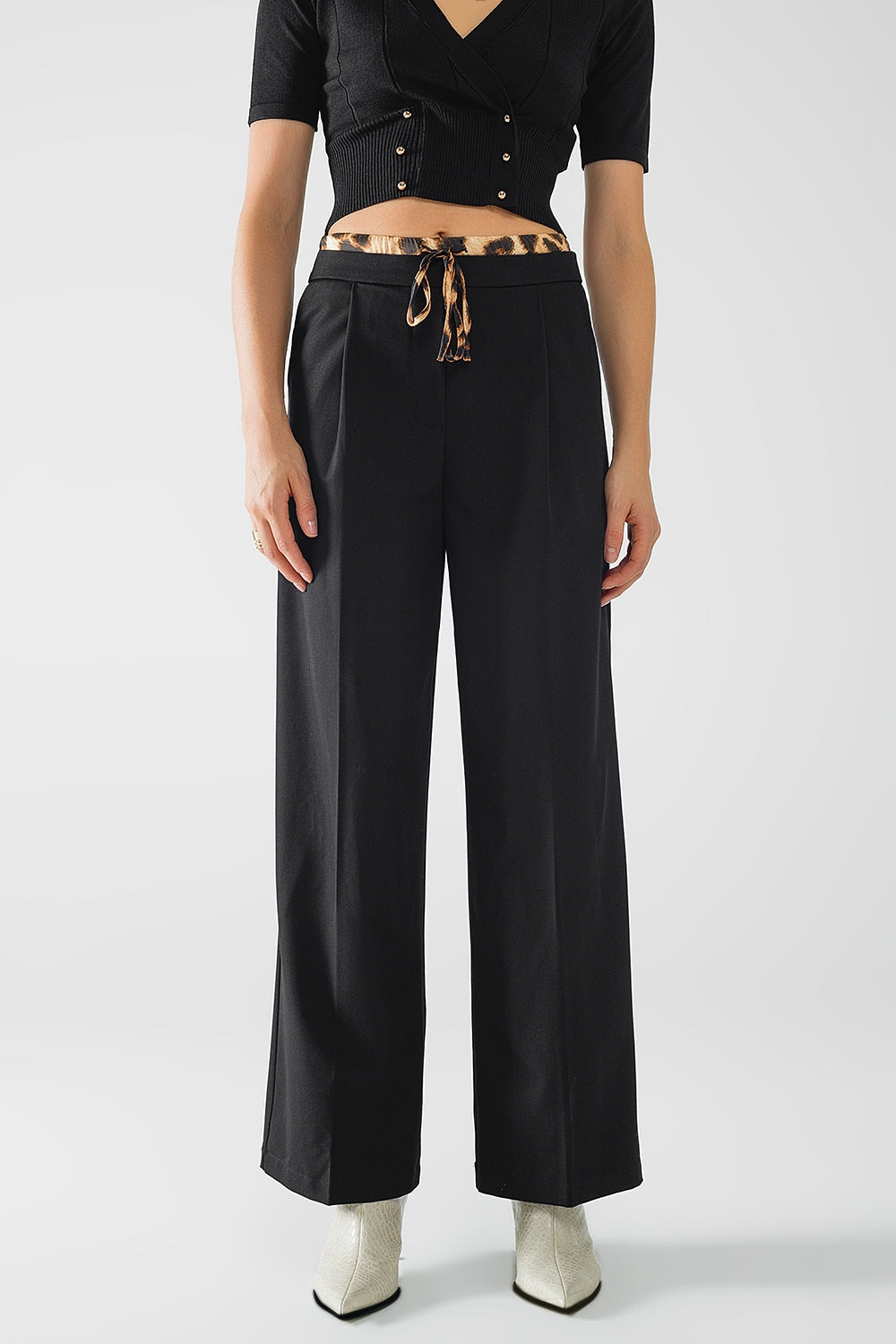 Q2 Long black pleated pants with leopard detail at the waist