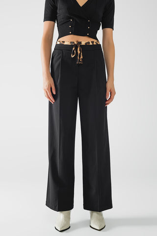 Long black pleated pants with leopard detail at the waist