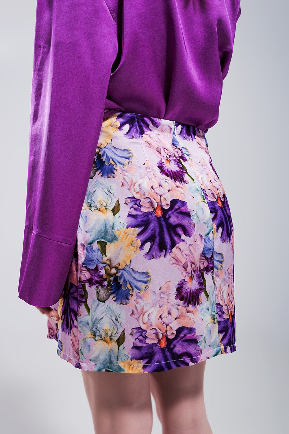 Mini skirt with knot front in purple clashing floral print Q2 Skirts BoutiqueLua