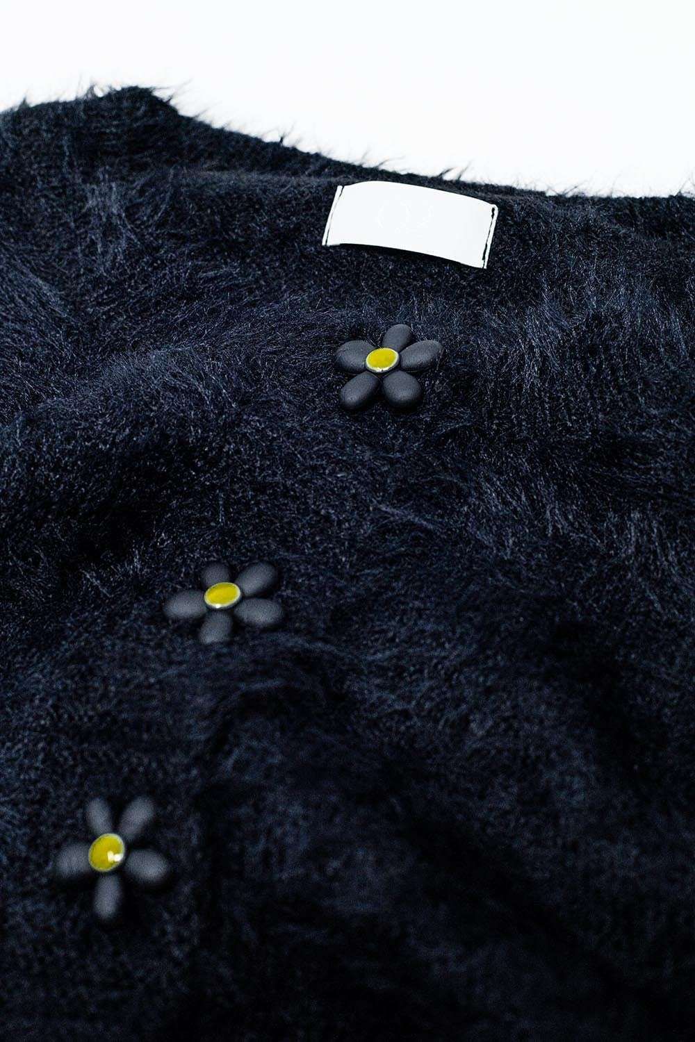 Short and fluffy black cardigan with flower buttons