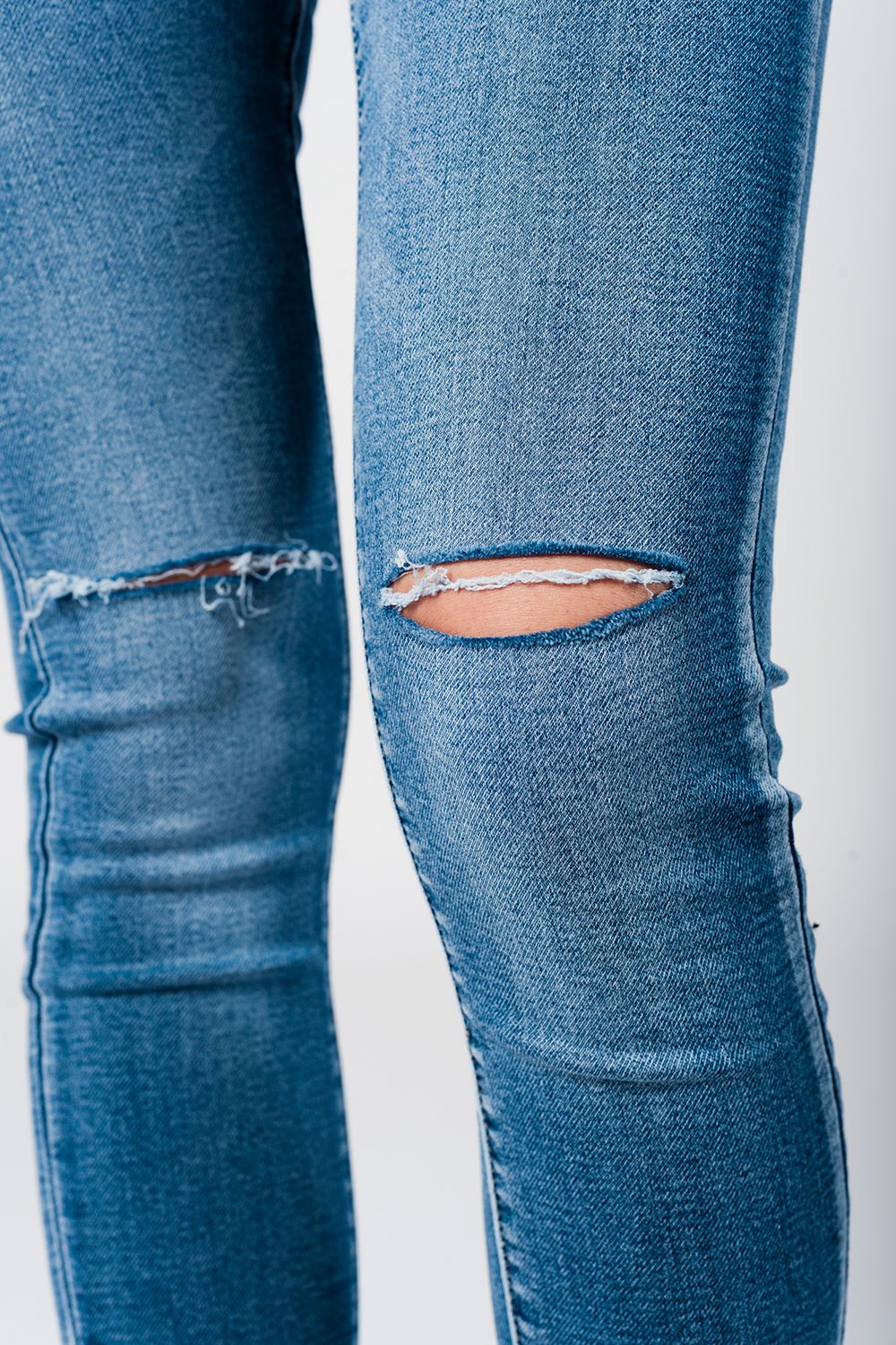 Skinny jeans in midwash with busted knees and chewed hems Q2 Jeans BoutiqueLua