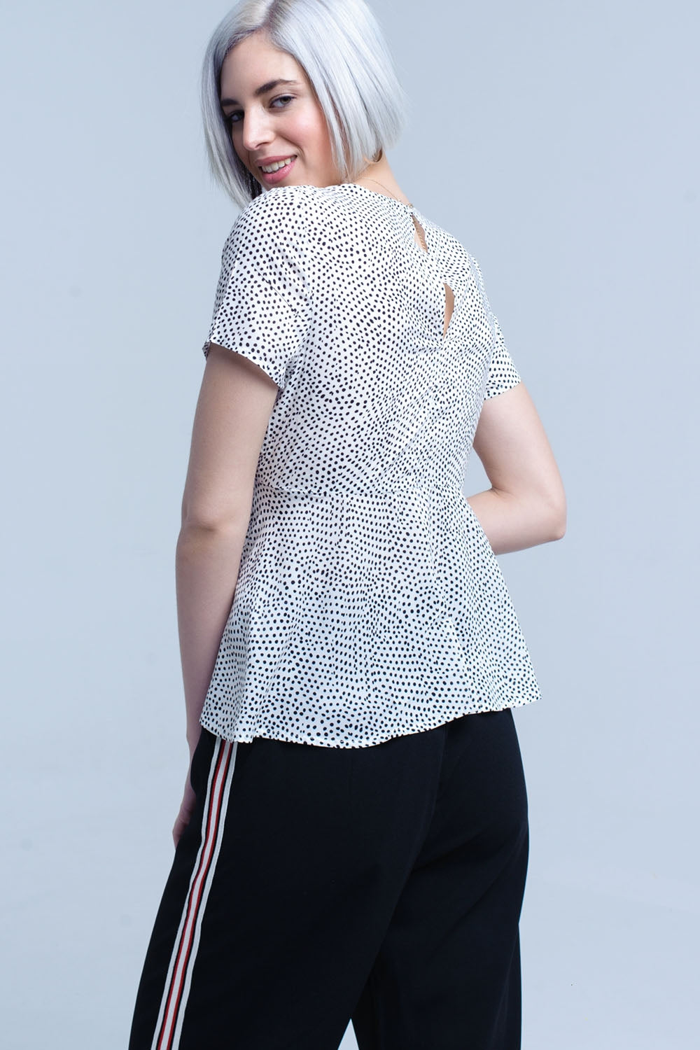 White polka dot top with ruffle hem Q2 Shirts BoutiqueLua